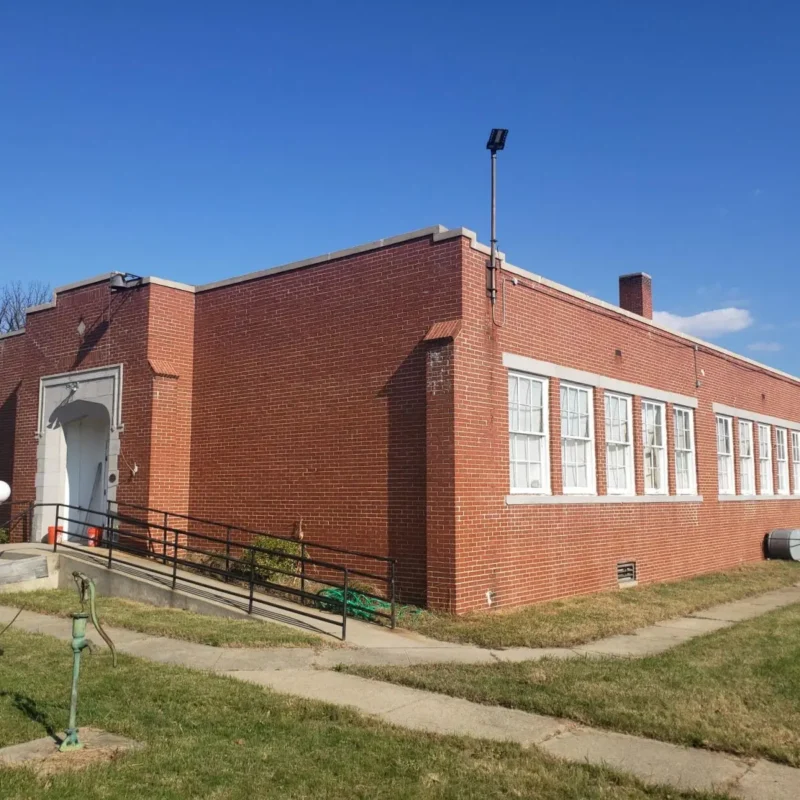 A red brick building with white windows.
